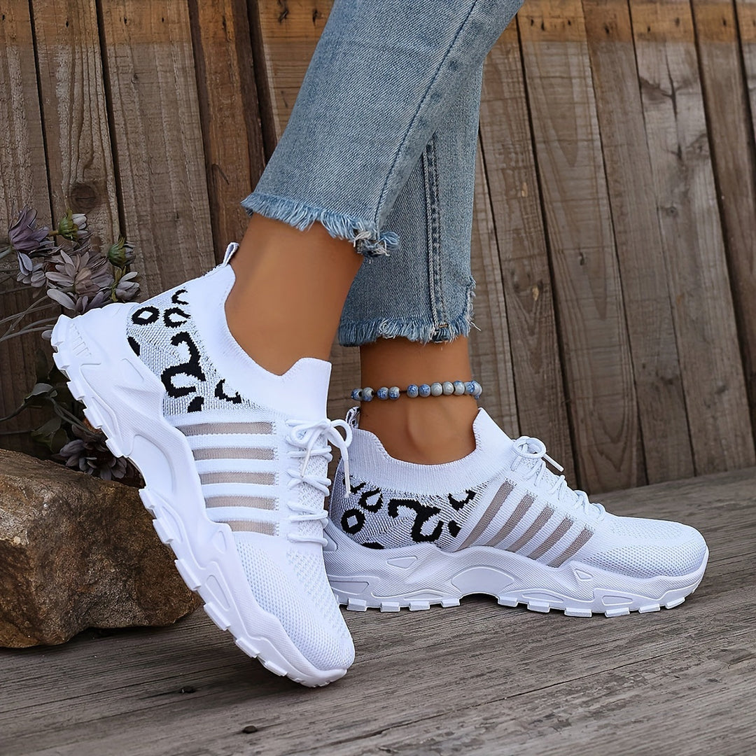 A woman walking in light, breathable comfort sneakers on a warm day.
