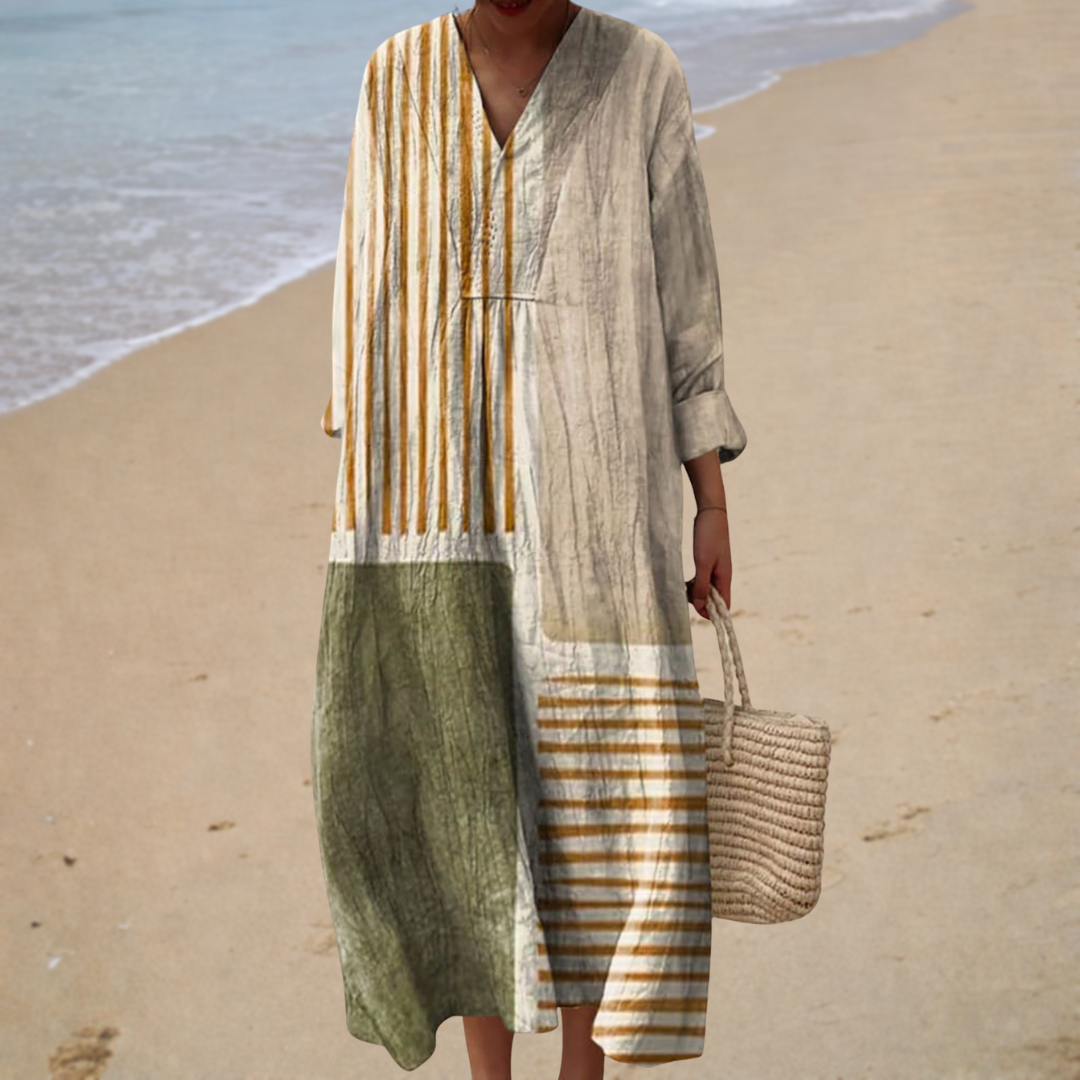 A woman in a floaty printed summer dress, the skirt moving lightly as she walks.