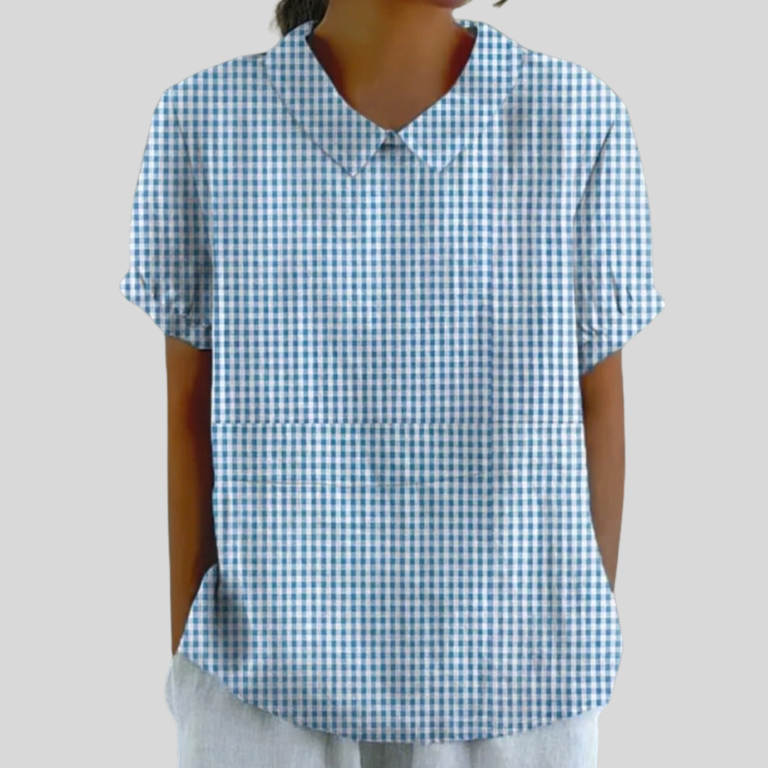 A woman wearing a blue gingham check top with a polo collar on a relaxed day out