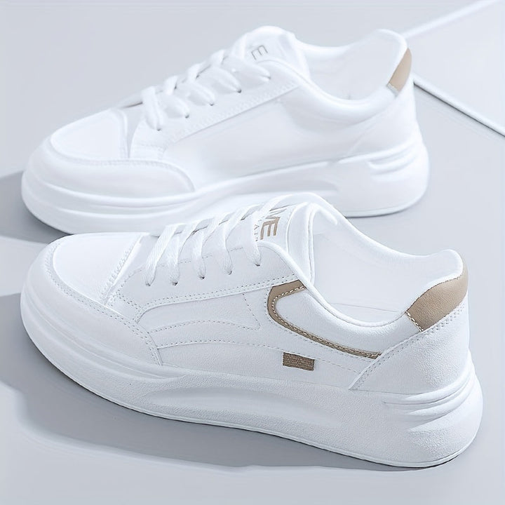 A woman in crisp white light comfort sneakers paired with jeans.