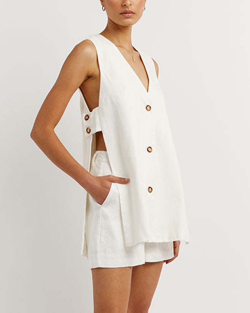 A woman wearing a sleeveless buttoned two-piece set