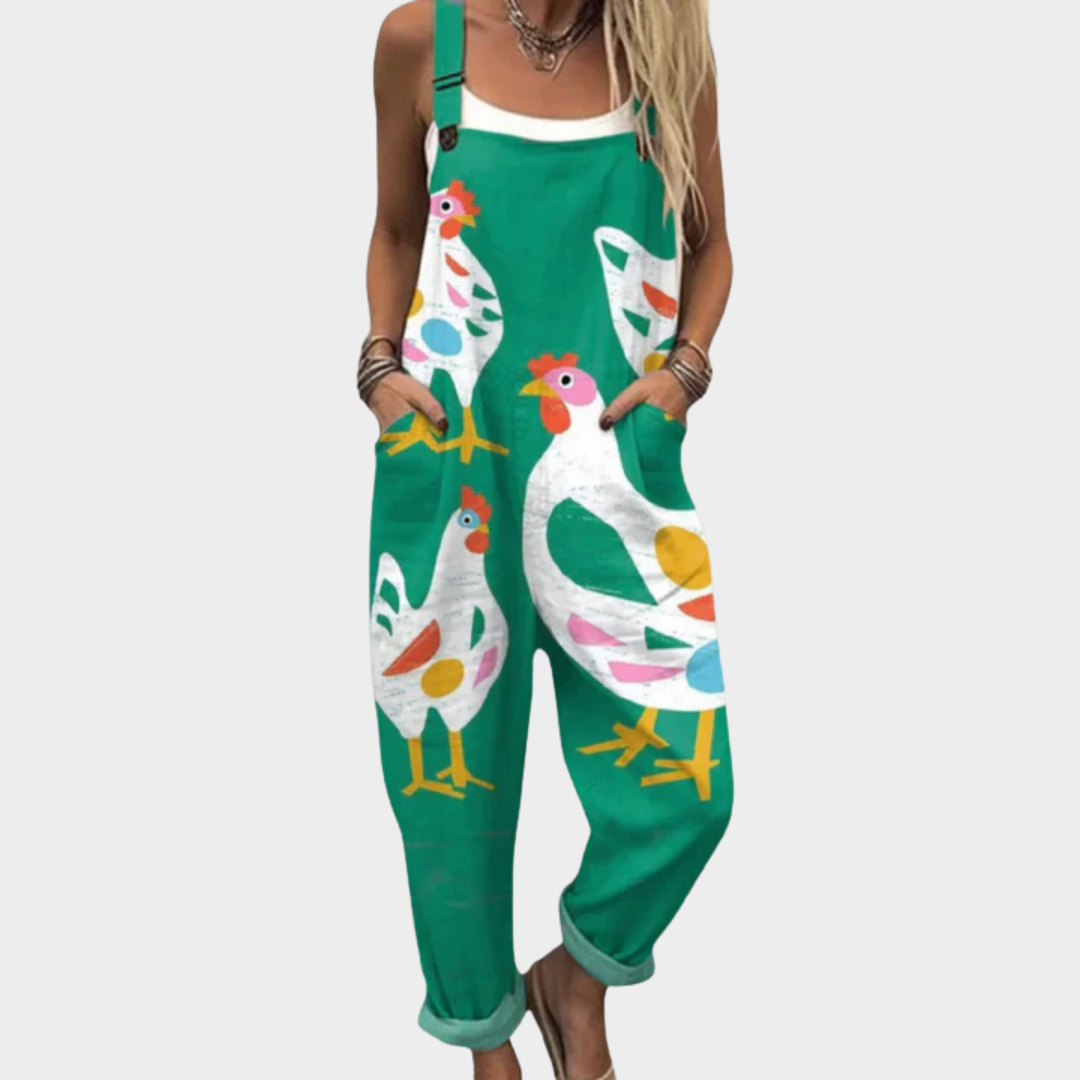 A woman in green overalls with a playful hen print, relaxed fit and adjustable straps.