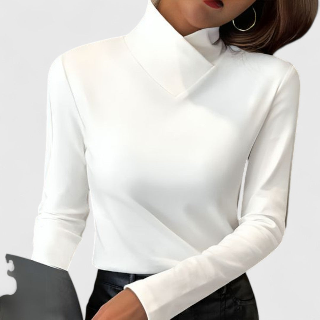 A woman wearing an elegant stand-collar sweater, slim and refined with a flattering line.