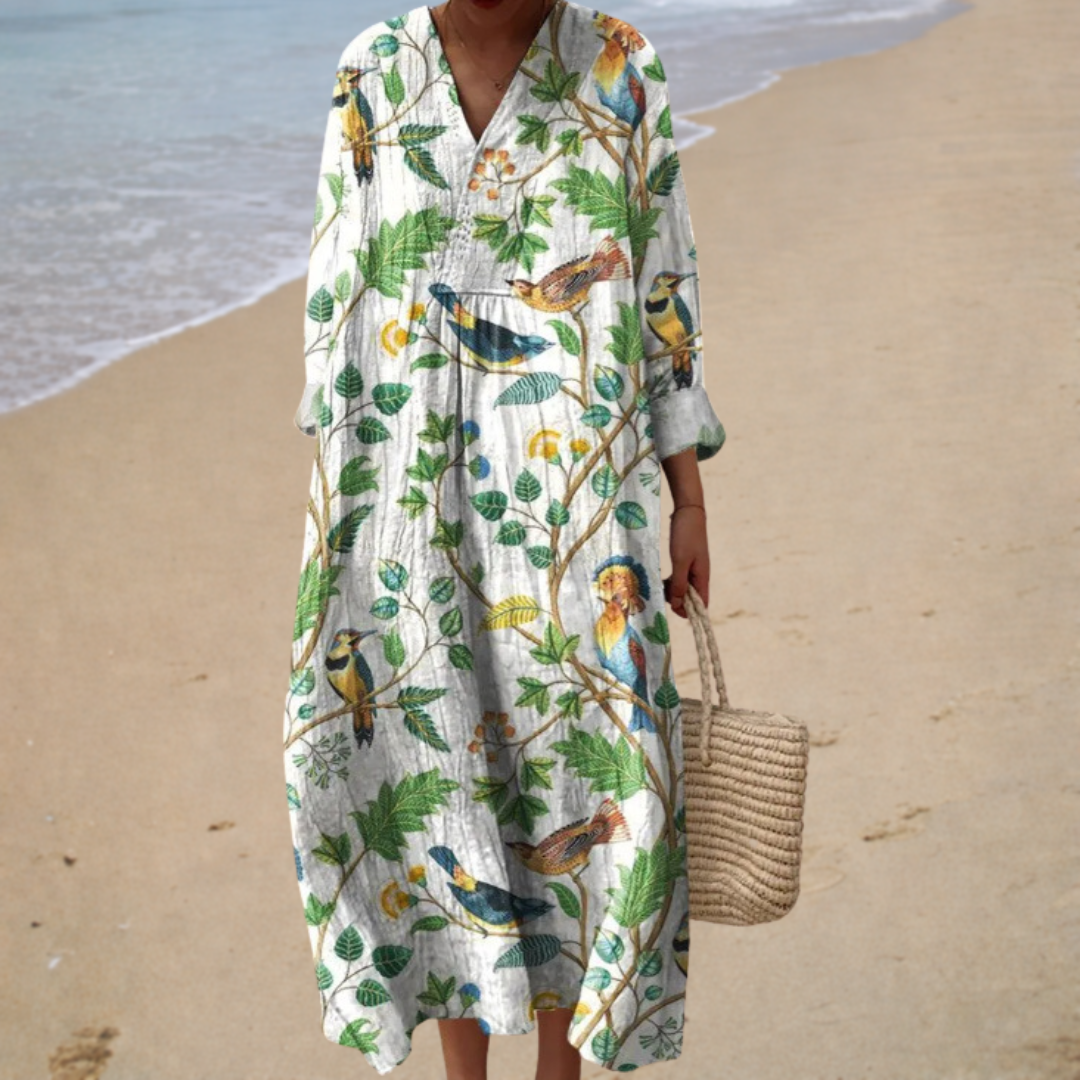 A woman wearing a flowing printed summer dress that moves gracefully on a warm day.