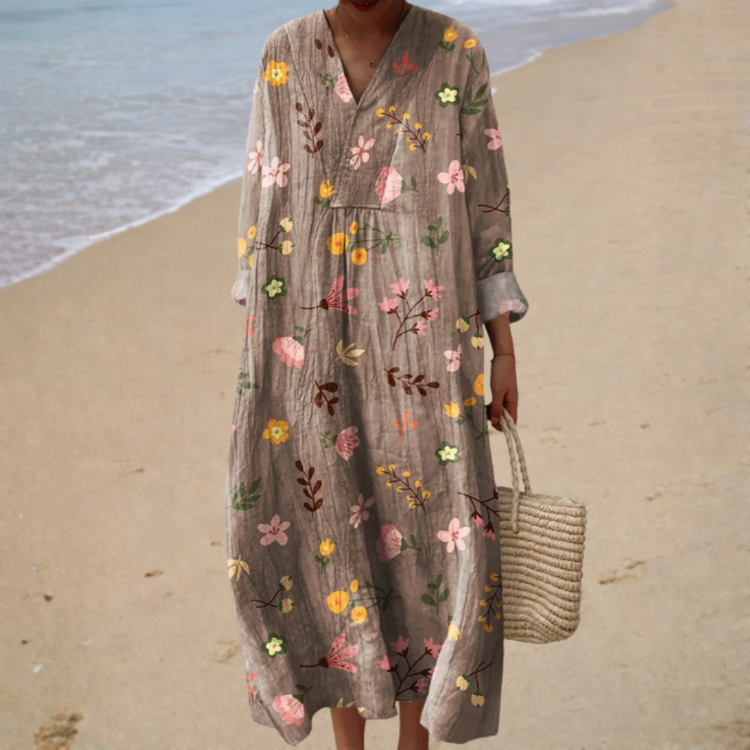A woman wearing a fluttering printed summer dress that moves softly in the warm breeze.