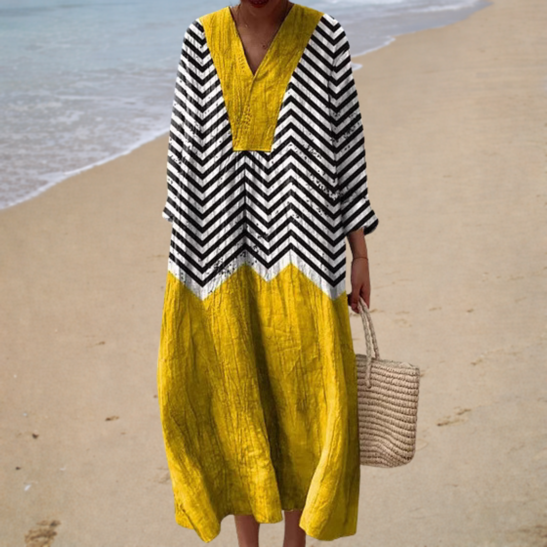 A woman in a breezy printed summer dress, relaxed and cool on a hot day.