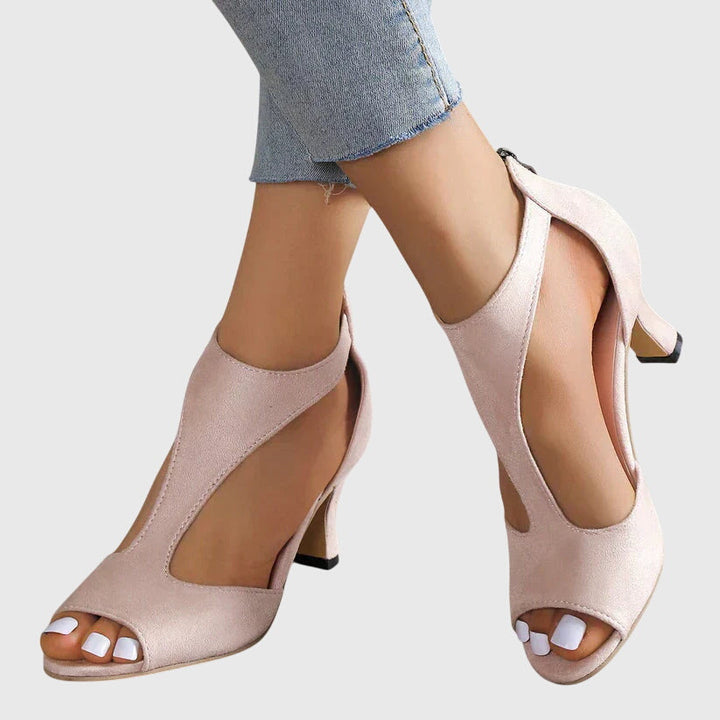 A woman in soft pink supportive heels walking with ease through her day.
