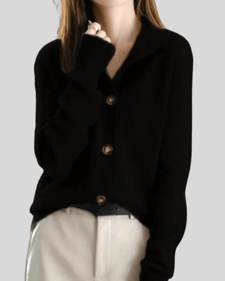 A woman wearing a beige retro button cardigan layered over a dress, warm and elegant.