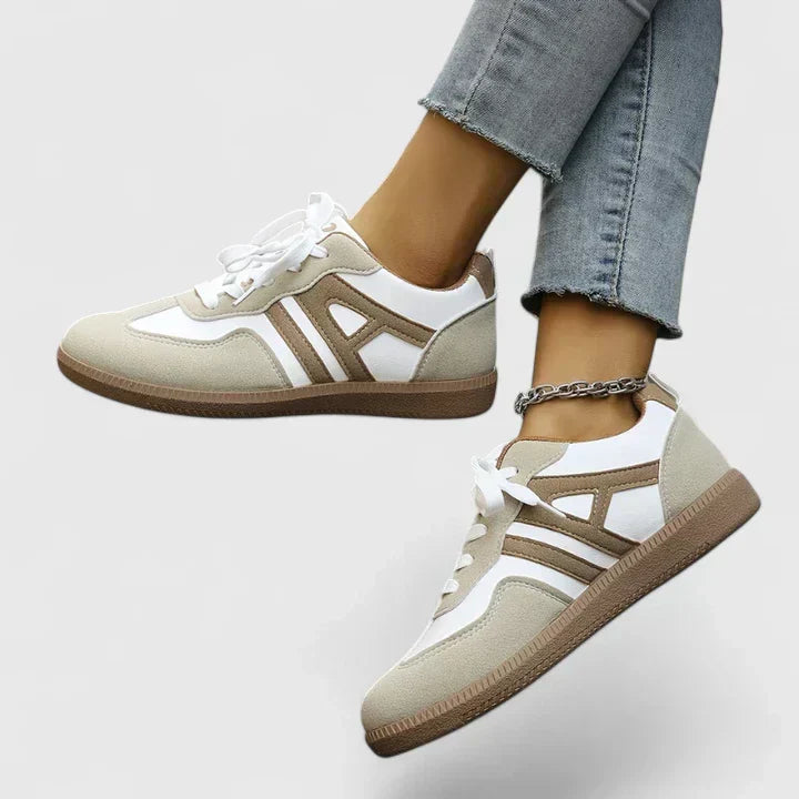 A woman wearing khaki and white orthopaedic sneakers on a relaxed walk.