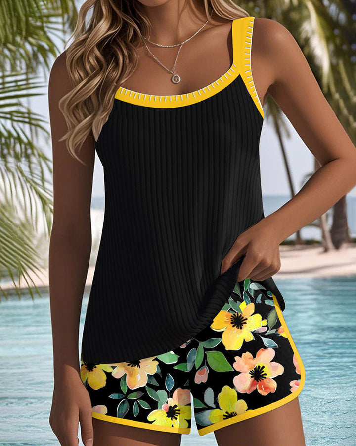 A woman at the water's edge in a bright printed two-piece tankini, relaxed and confident.