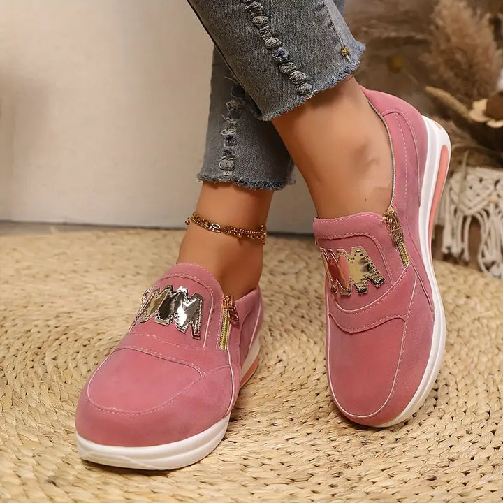 A woman wearing cushioned side-zip sneakers with a relaxed everyday outfit