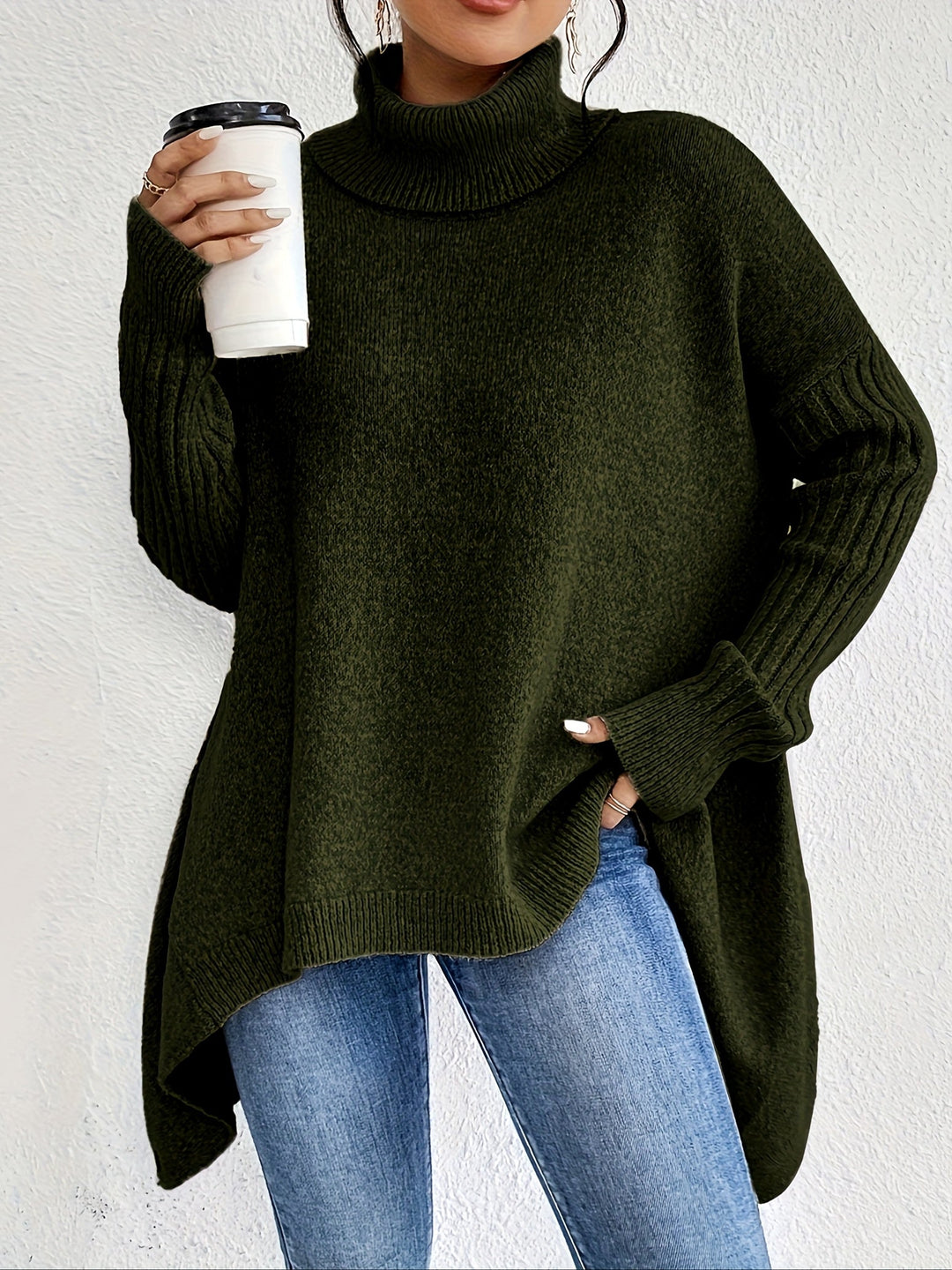 A woman wearing a stand-collar sweater with a chic asymmetric drape, warm and polished.