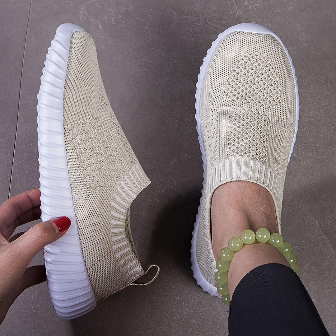 A woman slipping on ultralight sock-style sneakers that hug the foot.