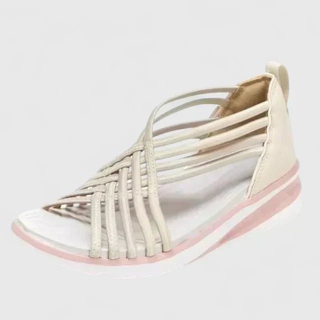 A woman walking with ease in elegant wide-fit everyday sandals with a cushioned footbed.