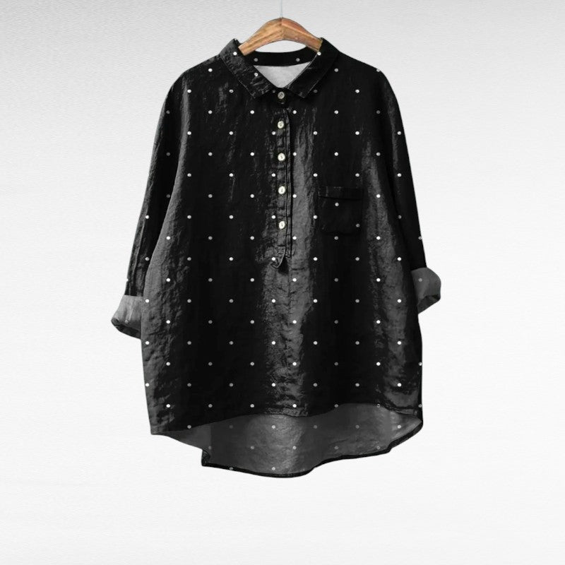 A woman wearing an elegant patterned summer blouse, looking fresh and stylish on a warm day.