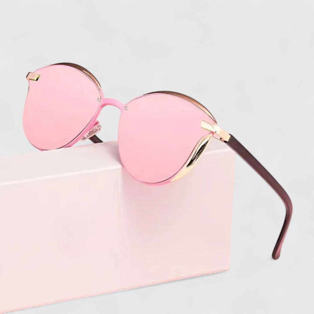 A woman wearing minimalist polarised gradient sunglasses on a bright day.