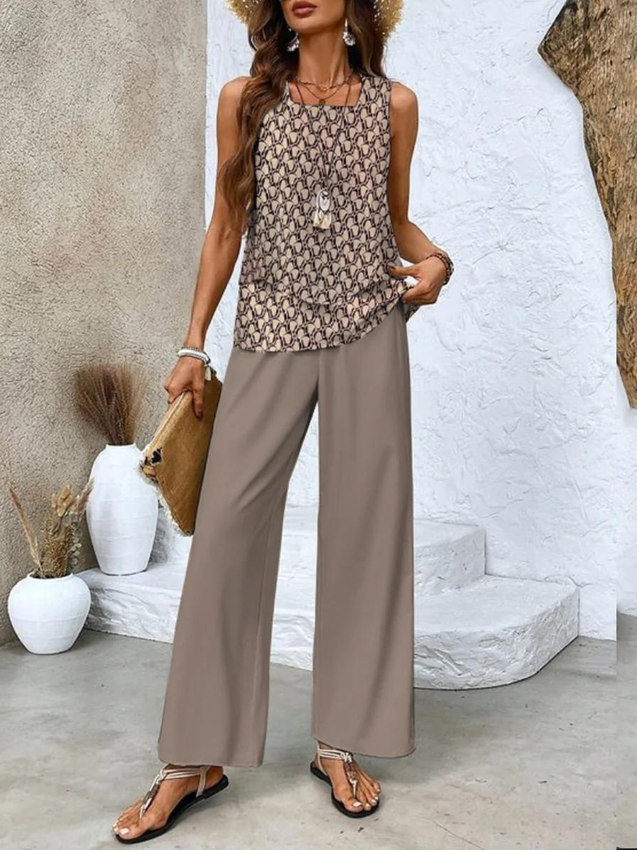 A woman wearing a layered sleeveless top with leaf-print wide-leg pants, light and elegant.