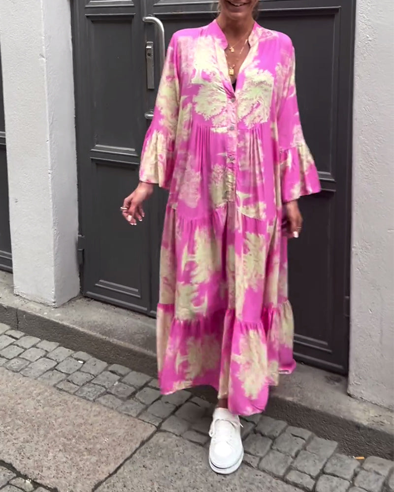 Woman wearing the Sylvie flowing maxi dress with a delicate print and V-neckline, the skirt moving softly as she walks.