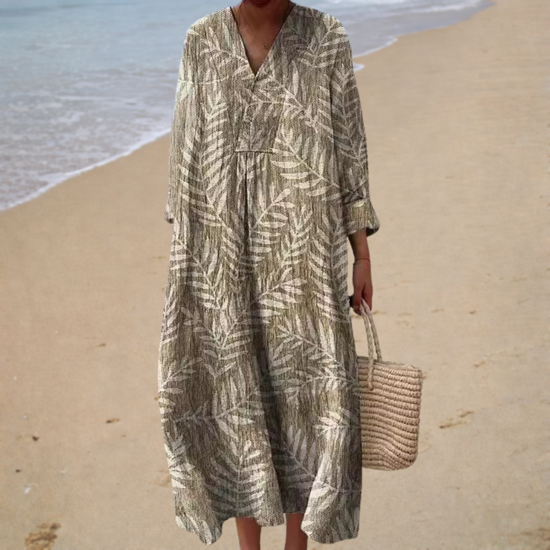 A woman wearing a fluttering printed summer dress that catches the breeze on a warm day.