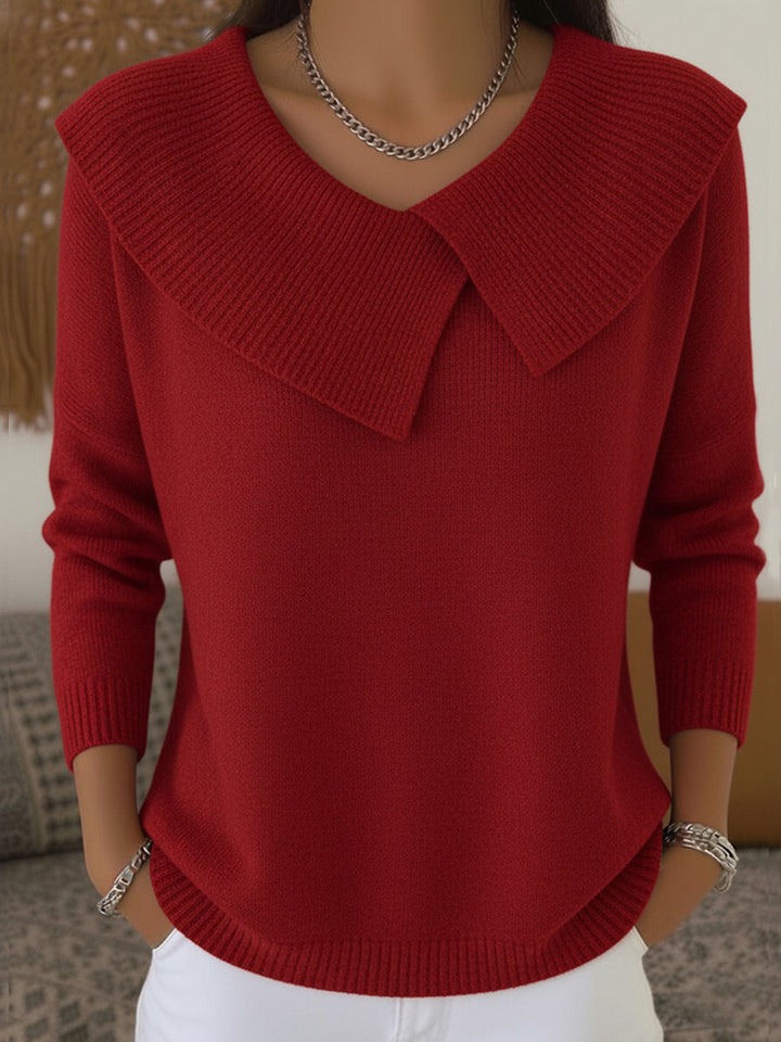 A woman wearing a soft collared sweater styled elegantly for a festive occasion.