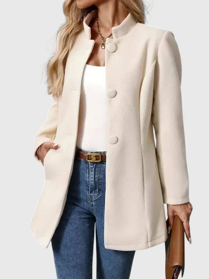 A woman wearing a tailored jacket with a neat stand collar and a button front