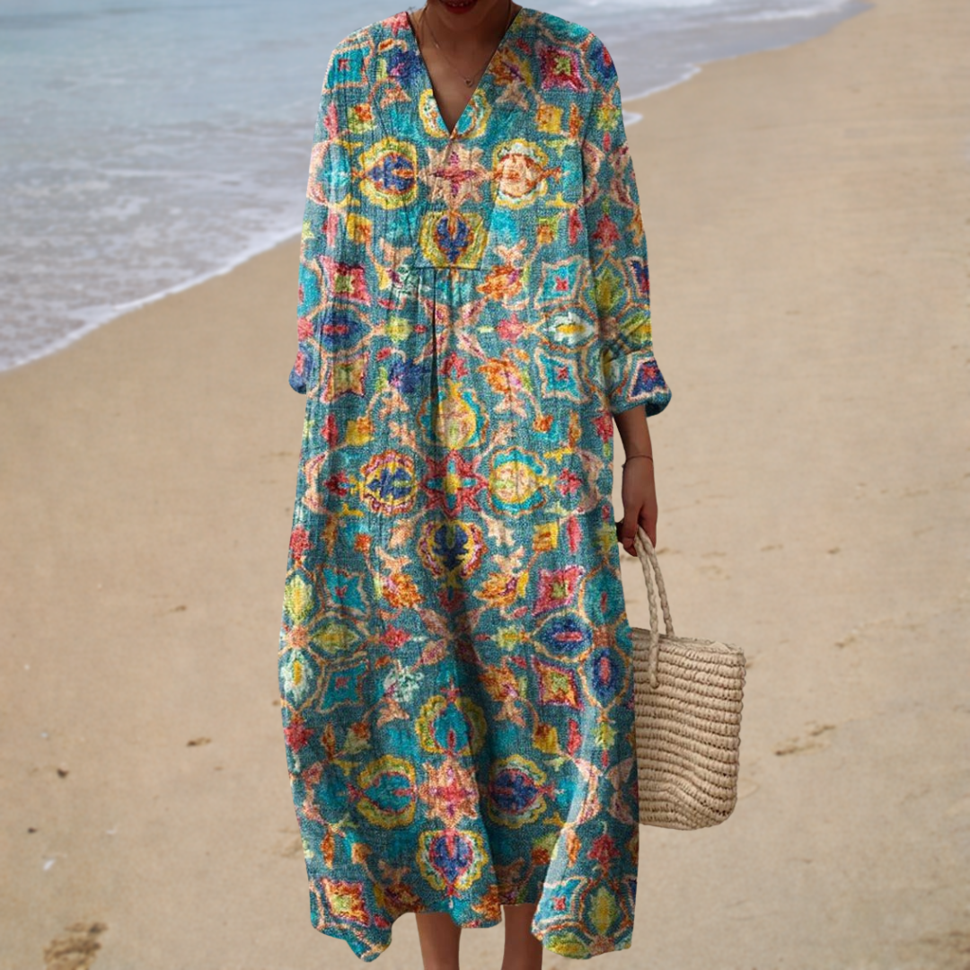 A woman wearing a fluttering printed summer dress that sways softly in the warm air.