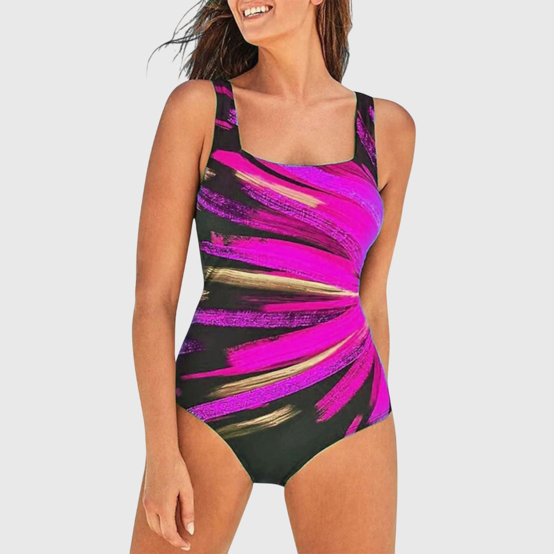 A woman wearing a figure-flattering swimsuit with a fresh summer print, relaxed by the pool.