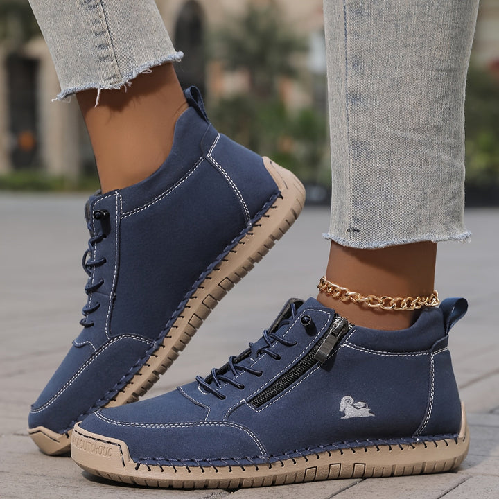A woman standing comfortably in wide-fit therapeutic comfort shoes