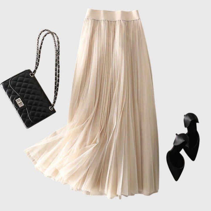 A woman in a flowing layered flared skirt, styled elegantly for a special day-to-night look.