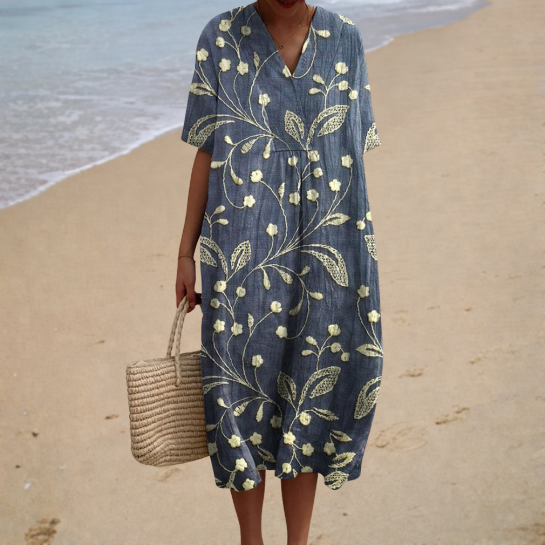 A woman wearing a flowing, softly patterned summer dress on an easy, sunlit day out.