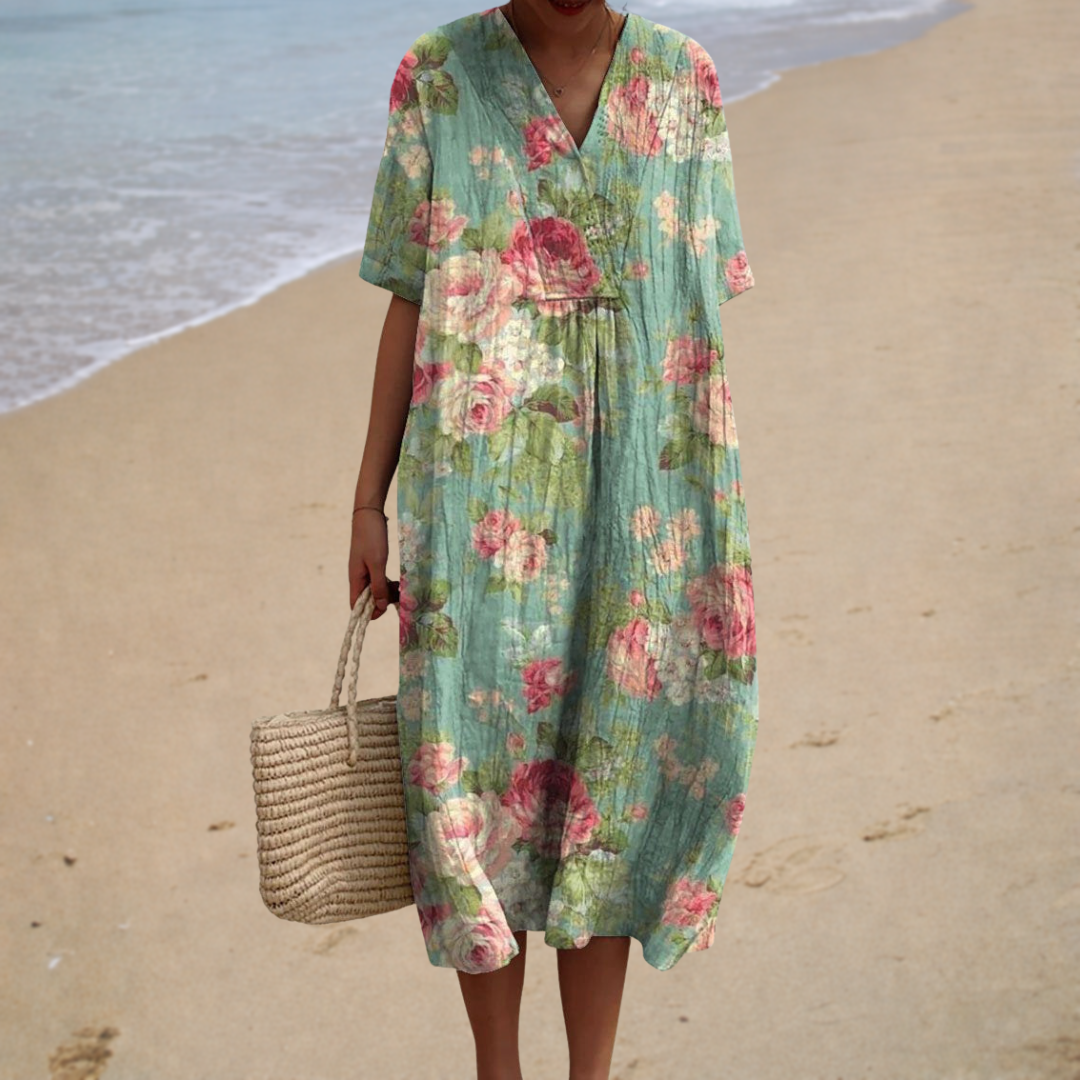 A woman in a light, flowing summer dress relaxing outdoors on a warm, bright day.
