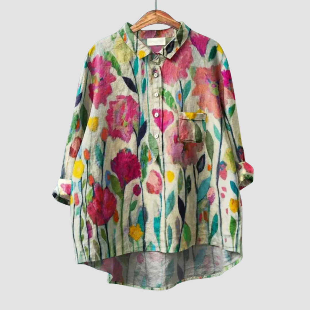 Woman wearing a soft printed summer blouse with a light, flowing silhouette.