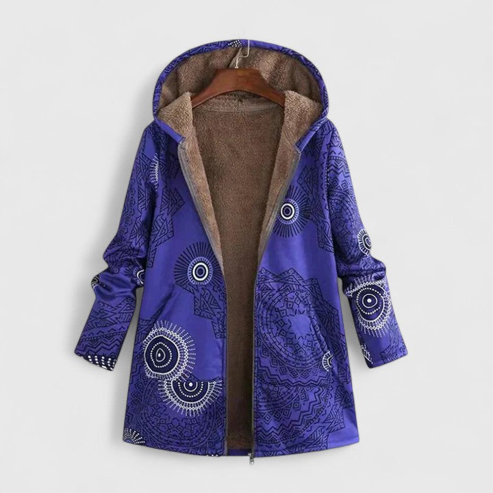 A woman wearing a geometric-print boho jacket, warmly layered on a winter day out.