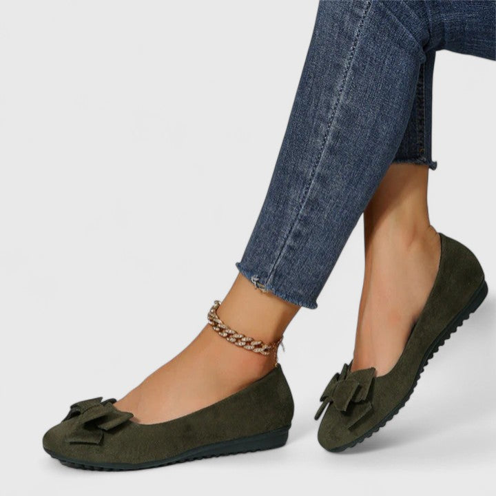A pair of olive-green ballet flats with a soft bow at the rounded toe.