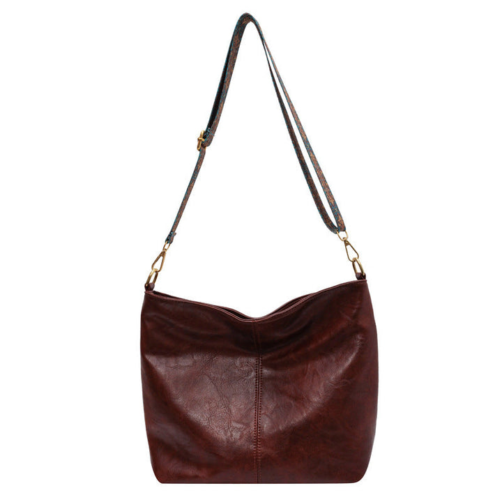 A woman carrying a vintage-style bag with a shoulder strap on a day out