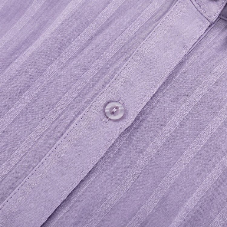 A woman wearing a button-front blouse with matching shorts