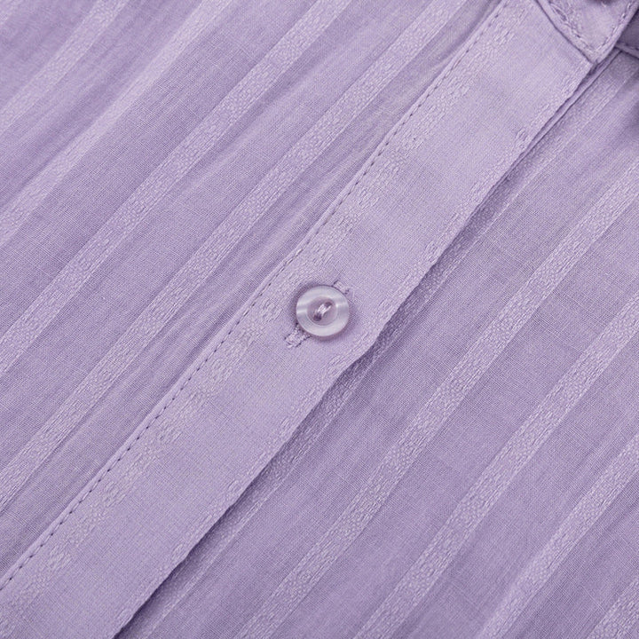A woman wearing a button-front blouse with matching shorts