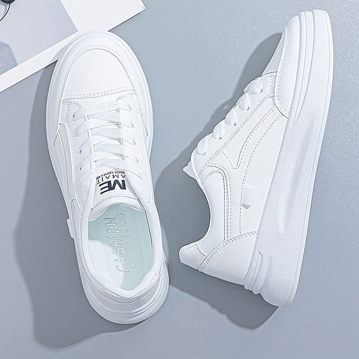 A woman in crisp white light comfort sneakers paired with jeans.