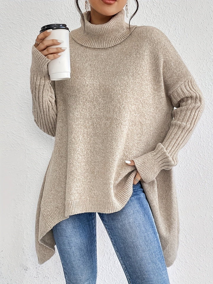 A woman wearing a stand-collar sweater with a chic asymmetric drape, warm and polished.