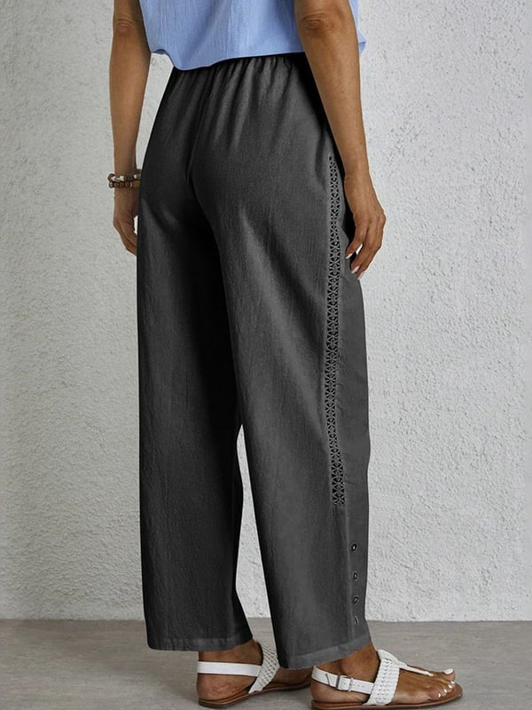 Woman wearing relaxed button-detail pants with a simple top, out for the day.