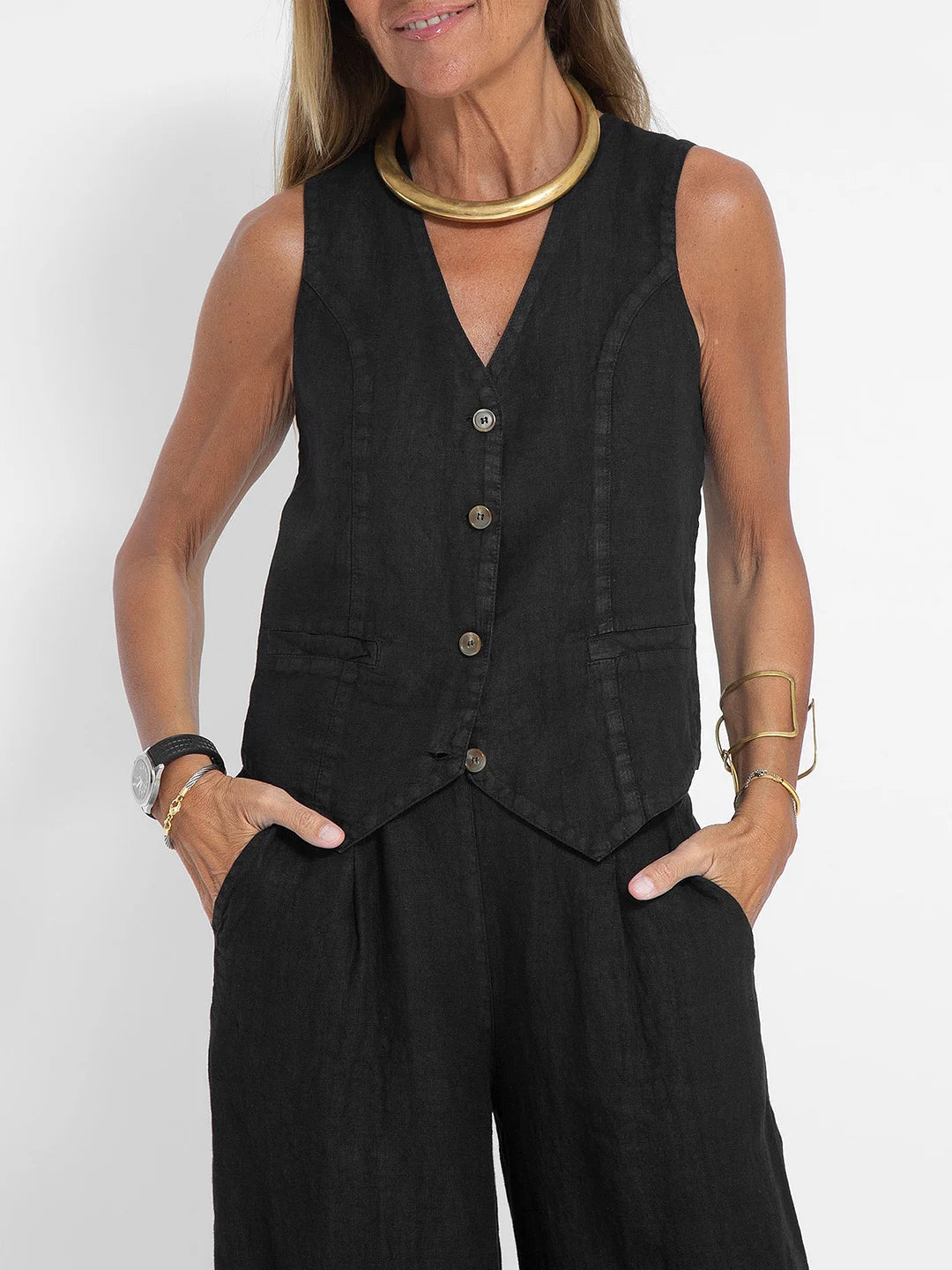 A woman wearing a tailored waistcoat with flowing wide-leg pants