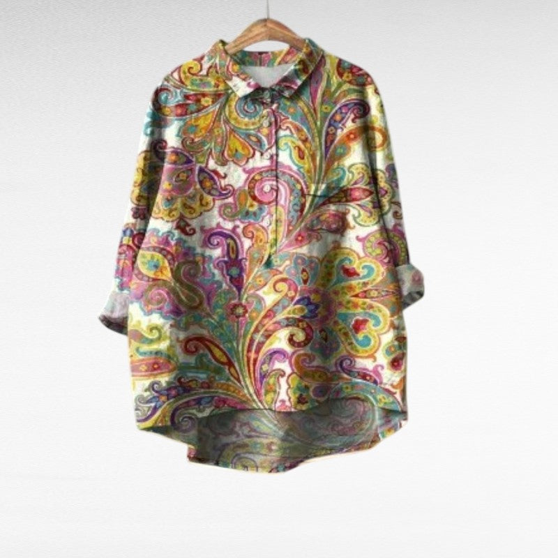 A woman wearing a light artful-print summer blouse on a warm day