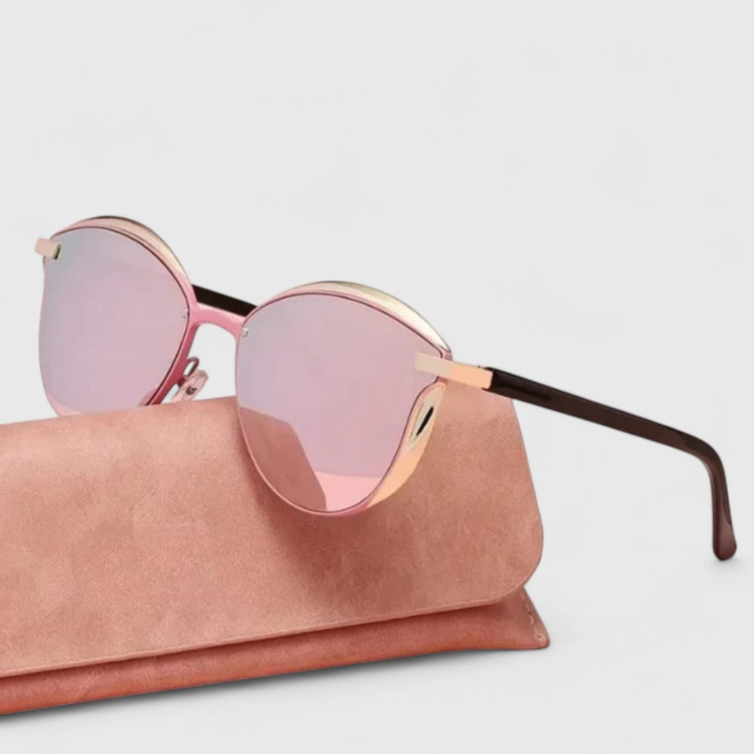 A woman wearing minimalist polarised gradient sunglasses on a bright day.