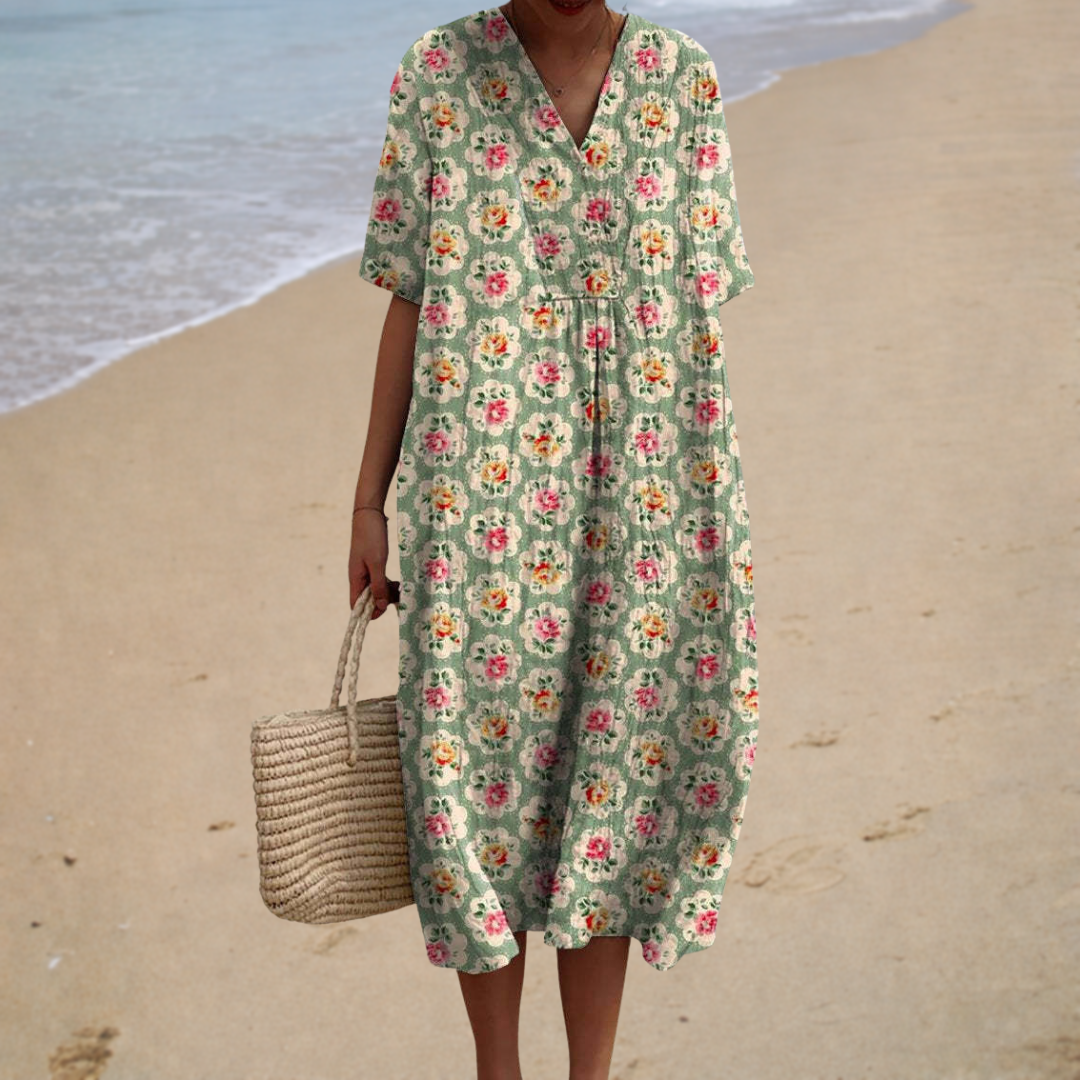 A woman wearing a relaxed printed summer dress with a soft, flowing drape on a summer day.