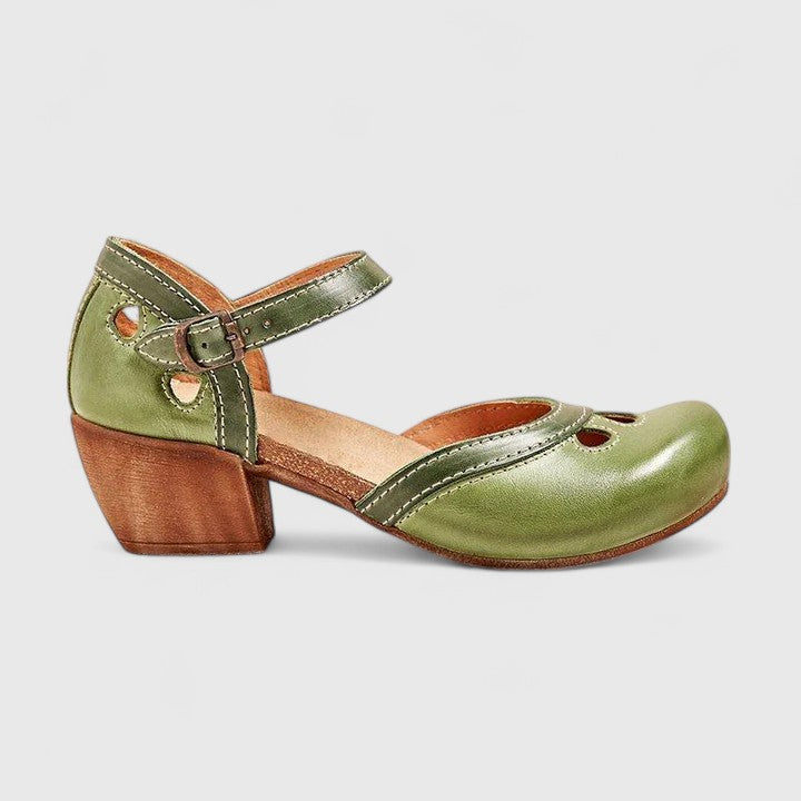 A woman in blue and green retro block heel shoes at a summer garden party.