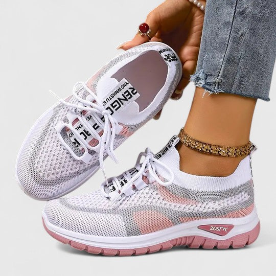 A woman lacing up light, breathable orthopaedic sneakers before a walk.