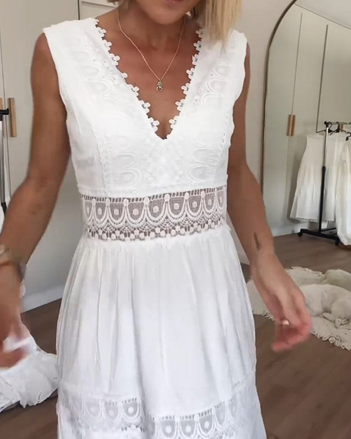 Woman wearing the April™ camisole maxi dress with delicate detailing and a flowing skirt at a summer gathering.