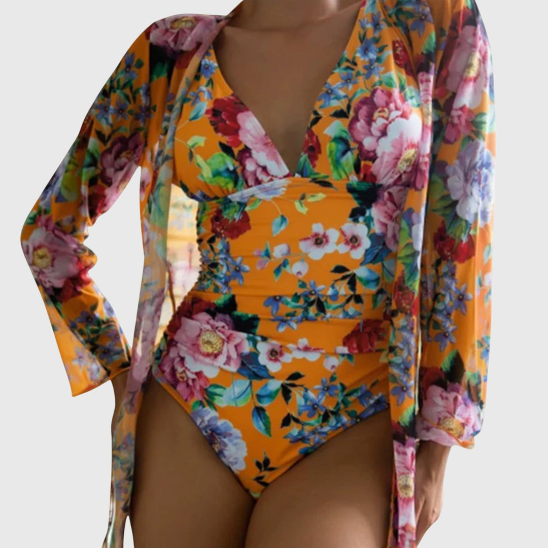 A woman relaxing by the pool in an airy printed swimsuit, glowing and carefree in the summer sun.