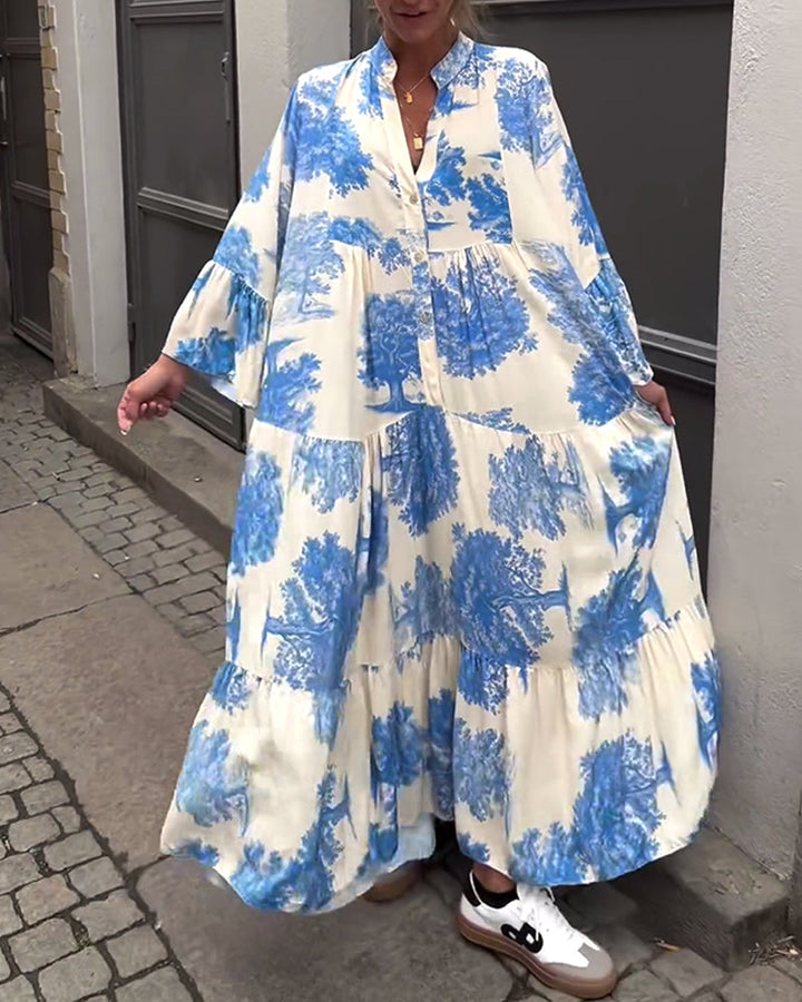 Woman wearing the Sylvie flowing maxi dress with a delicate print and V-neckline, the skirt moving softly as she walks.