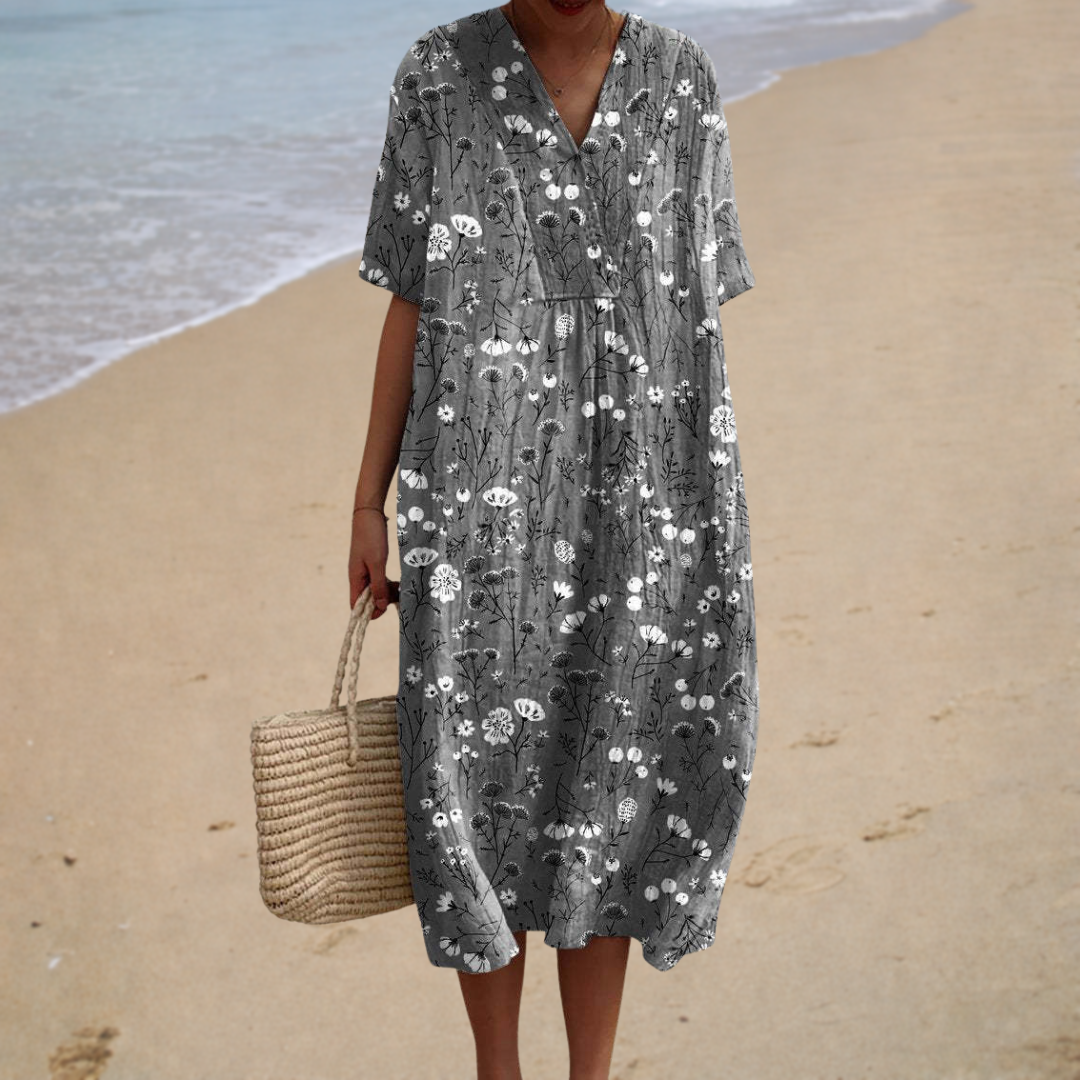 A woman wearing a relaxed printed summer dress, light and elegant on a sunny day.